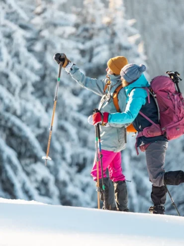 Two,Women,Walk,In,The,Snow,,Winter,Trekking,,Two,People